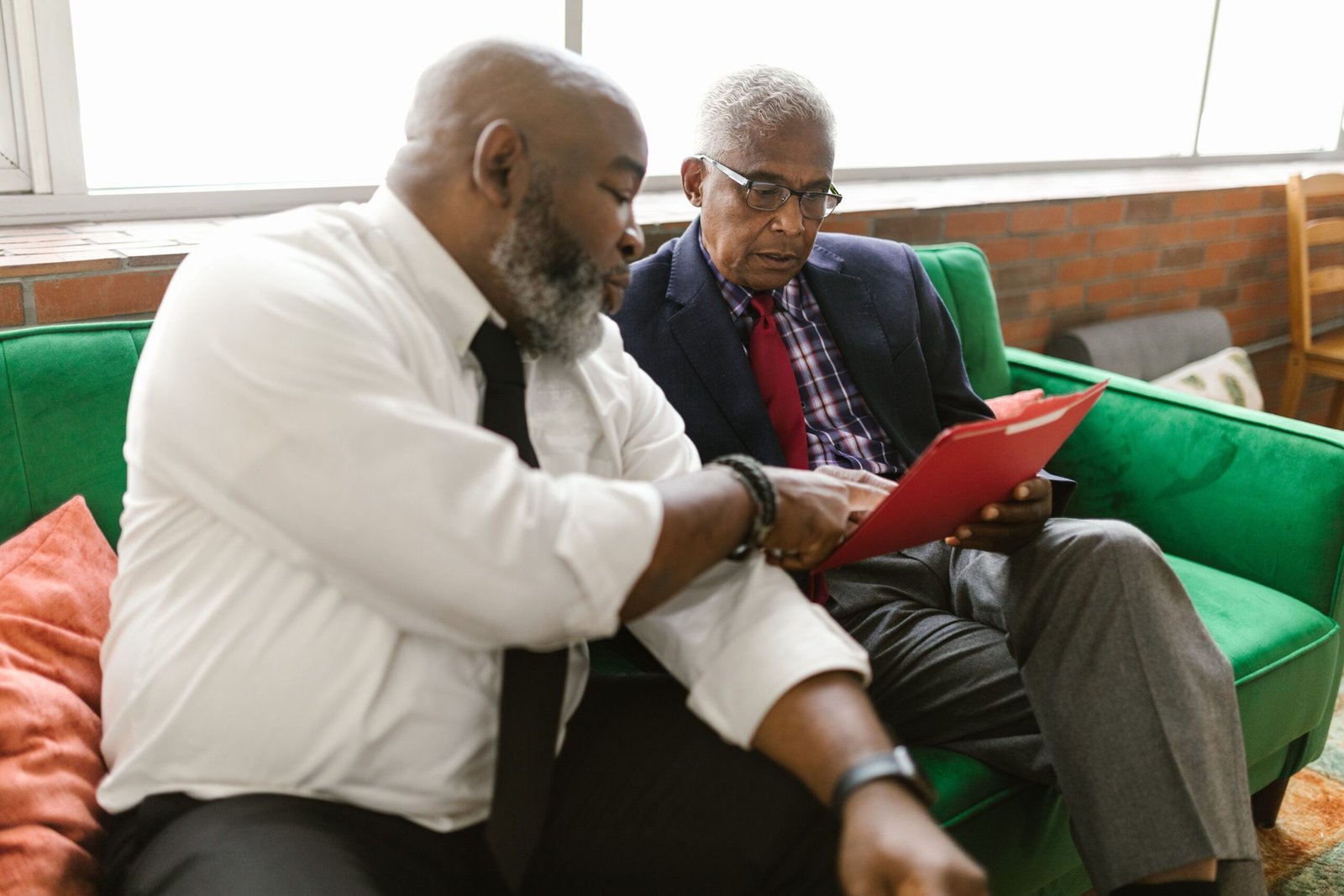 Senior homeowners reviewing reverse mortgage documents together at age 62 or older